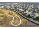 Aerial view of a residential community with houses and a walking path at 22103 Blazing Star Run, Land O Lakes, FL 34637