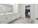Double vanity bathroom with walk-in closet at 22103 Blazing Star Run, Land O Lakes, FL 34637