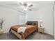Cozy bedroom with a brown comforter, nightstand, and ceiling fan at 22103 Blazing Star Run, Land O Lakes, FL 34637