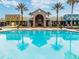 Resort-style pool with palm trees and reflection at 22103 Blazing Star Run, Land O Lakes, FL 34637