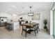 Open concept dining room with modern chandelier and kitchen views at 22103 Blazing Star Run, Land O Lakes, FL 34637