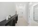 Modern entryway with a black console table and light gray tile floor at 22103 Blazing Star Run, Land O Lakes, FL 34637