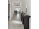 Bright and airy entryway with a long black console table and light tile floors at 22103 Blazing Star Run, Land O Lakes, FL 34637
