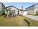 One-story house with gray siding, white garage door, and palm trees at 22103 Blazing Star Run, Land O Lakes, FL 34637