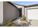 Modern dark brown front door with a white garage door to the side at 22103 Blazing Star Run, Land O Lakes, FL 34637