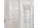 Long hallway with light walls, tile floors, and doors to other rooms at 22103 Blazing Star Run, Land O Lakes, FL 34637