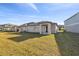 Back exterior view of house with covered patio at 22103 Blazing Star Run, Land O Lakes, FL 34637