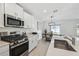 Modern kitchen with stainless steel appliances and white cabinetry at 22103 Blazing Star Run, Land O Lakes, FL 34637