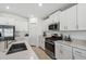 Modern kitchen with stainless steel appliances and white cabinetry at 22103 Blazing Star Run, Land O Lakes, FL 34637