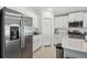 Bright kitchen featuring stainless steel refrigerator and white cabinets at 22103 Blazing Star Run, Land O Lakes, FL 34637