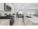 Modern kitchen with stainless steel appliances and white cabinetry at 22103 Blazing Star Run, Land O Lakes, FL 34637