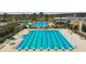 Community lap pool with surrounding lounge chairs at 22103 Blazing Star Run, Land O Lakes, FL 34637