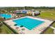 Community lap pool, lounge chairs, and clubhouse in background at 22103 Blazing Star Run, Land O Lakes, FL 34637
