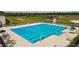 Community lap pool with multiple lanes and surrounding lounge chairs at 22103 Blazing Star Run, Land O Lakes, FL 34637