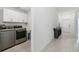 Bright laundry room with washer, dryer, and upper cabinets at 22103 Blazing Star Run, Land O Lakes, FL 34637