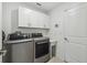 Clean laundry room with stacked washer and dryer at 22103 Blazing Star Run, Land O Lakes, FL 34637