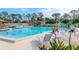 Refreshing community pool with surrounding lounge chairs and landscaping at 2468 Laurelwood Dr # B, Clearwater, FL 33763