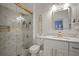 Modern bathroom with a walk-in shower, updated vanity, and gold fixtures at 305 E Hanlon St, Tampa, FL 33604