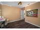 Bedroom with hardwood floors, large wall art and ceiling fan at 305 E Hanlon St, Tampa, FL 33604