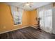 Bright bedroom with wood-look floors and window at 305 E Hanlon St, Tampa, FL 33604