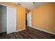 Bedroom with double door closet and wood-look floors at 305 E Hanlon St, Tampa, FL 33604