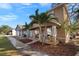 Two-story house with front porch, landscaping, and palm trees at 305 E Hanlon St, Tampa, FL 33604