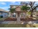 Two-story house with front porch, landscaping, and palm trees at 305 E Hanlon St, Tampa, FL 33604