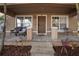 Front porch with seating and entry to a two-story house at 305 E Hanlon St, Tampa, FL 33604