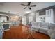 Bright living room with hardwood floors, sectional sofa, and ceiling fan at 305 E Hanlon St, Tampa, FL 33604