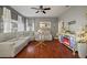 Living room with hardwood floors, sectional sofa, and electric fireplace at 305 E Hanlon St, Tampa, FL 33604