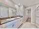 Double vanity bathroom with granite countertop and access to closet at 3059 Nubbin Ridge Ln, Zephyrhills, FL 33540
