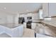 Modern kitchen features white cabinets, granite countertops, and black appliances at 3059 Nubbin Ridge Ln, Zephyrhills, FL 33540