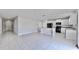 Open kitchen with island and black appliances at 3059 Nubbin Ridge Ln, Zephyrhills, FL 33540