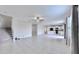 Open living room with tile floors and a view into the kitchen at 3059 Nubbin Ridge Ln, Zephyrhills, FL 33540