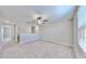 Spacious loft area features neutral carpeting and ceiling fan at 3059 Nubbin Ridge Ln, Zephyrhills, FL 33540