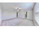 Main bedroom with ceiling fan, carpet, and en-suite bathroom view at 3059 Nubbin Ridge Ln, Zephyrhills, FL 33540