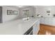 Modern kitchen with white cabinets, marble countertops, and gold hardware at 3211 W Oakellar Ave, Tampa, FL 33611