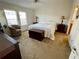 Sunlit main bedroom with neutral carpet, ceiling fan, two windows, and furniture at 34071 Avocado N Dr, Pinellas Park, FL 33781