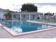 Large, welcoming community pool with a building alongside and plenty of seating for residents to enjoy at 34071 Avocado N Dr, Pinellas Park, FL 33781