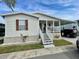 Single-wide manufactured home with covered porch and carport at 34071 Avocado N Dr, Pinellas Park, FL 33781