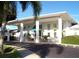 Well-maintained exterior with covered entrance, columns, landscaping and paved driveway at 34071 Avocado N Dr, Pinellas Park, FL 33781