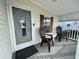 Front porch with two chairs and a small table at 34071 Avocado N Dr, Pinellas Park, FL 33781