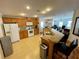 Bright kitchen features wooden cabinetry, modern appliances, and breakfast bar overlooking the living area at 34071 Avocado N Dr, Pinellas Park, FL 33781