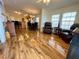 Open concept living room with hardwood floors and kitchen view at 34071 Avocado N Dr, Pinellas Park, FL 33781