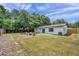 Backyard with fire pit and seating area, surrounded by trees and a privacy fence at 3445 10Th N Ave, St Petersburg, FL 33713