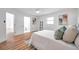 Bedroom with queen bed, en-suite bathroom, and light wood floors at 3445 10Th N Ave, St Petersburg, FL 33713