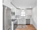 Modern white kitchen with stainless steel appliances and quartz countertops at 3445 10Th N Ave, St Petersburg, FL 33713