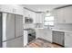 Modern kitchen with white cabinets, stainless steel appliances, and quartz countertops at 3445 10Th N Ave, St Petersburg, FL 33713