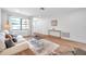 Living room with light wood floors, off-white sofa, and a coffee table at 3445 10Th N Ave, St Petersburg, FL 33713