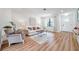 Living room with light wood floors, off-white sofa, and a coffee table at 3445 10Th N Ave, St Petersburg, FL 33713